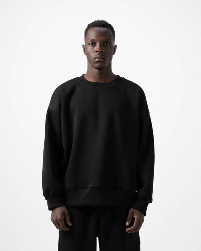 Person wearing a black outfit on a white background